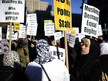 New York: Members of the Muslim community stage a rally prior to performing Friday prayers on Foley Square in support of Occupy Wall Street against police brutality and surveillance in New York, November 18, 2011. (AFP Photo/Emmanuel Dunand) 
